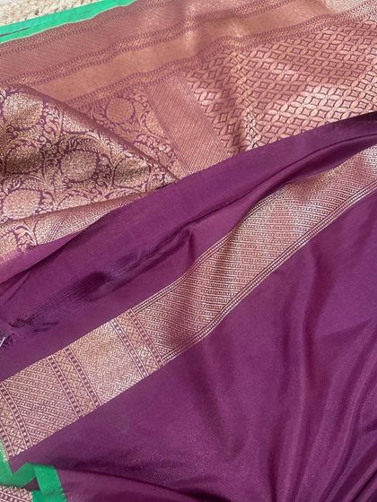 The plain wine-purple blouse piece with a simple green and gold border, perfect for a rich and traditional look.