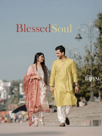 A lovely photo of a couple in colorful ethnic wear walking along the sunny promenade in Rishikesh.