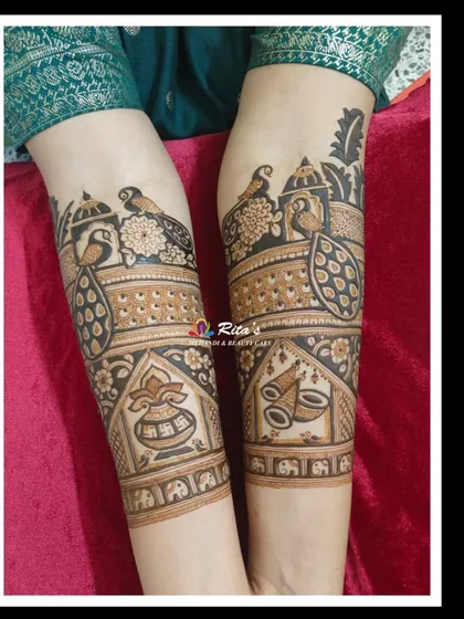Another angle of the detailed arm work, showing how the different traditional elements like peacocks, kalash, and dhol come together in a cohesive design.