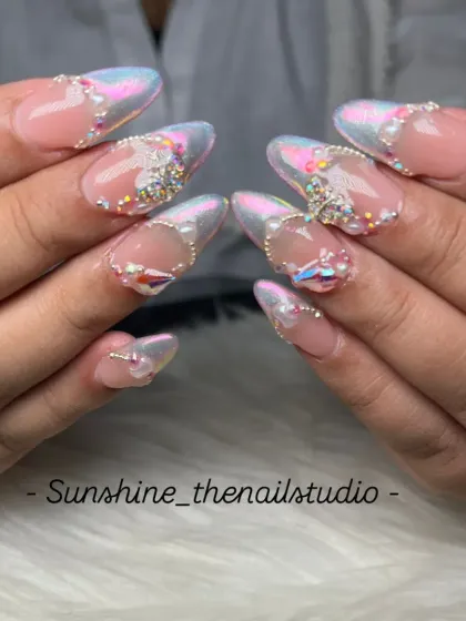 A mermaid chrome French manicure with heavy stone work for a fantasy look.