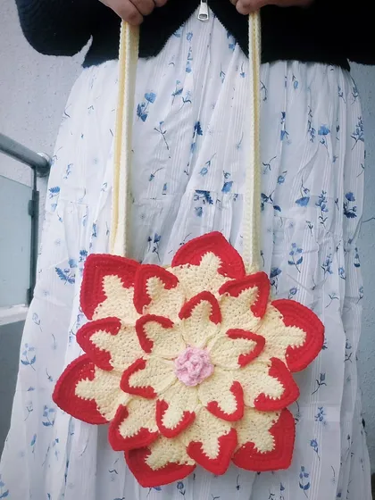 This is my custom-made Lotus Bag, a vibrant and playful shoulder bag that brings a pop of color to any outfit. The layered petal design is a great example of how I can turn a simple accessory into a piece of wearable art.