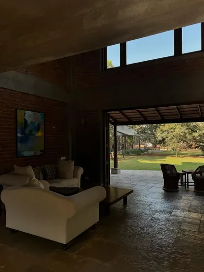 The living room at The Mango House, with its comfortable sofas and view out to the garden. The design is simple and unpretentious, focusing on creating a relaxed and welcoming environment.