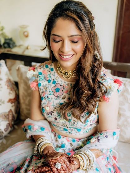 A playful and pretty Mehendi look. I used soft pink eyeshadow and a dewy base to create a fresh, youthful glow that matched her fun, floral Payal Singhal outfit.
