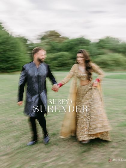An artistic motion-blur shot of the couple walking hand-in-hand through a field, creating a dreamy and dynamic memory of their London wedding day.