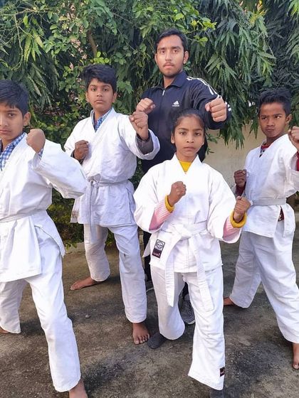 Posing with a small group of my young students. I work closely with them to build their confidence and teach them the core values of karate.