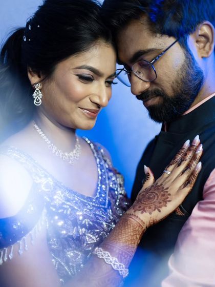 A creative portrait using a prism effect to create a dreamy, blue-toned image of the engaged couple.