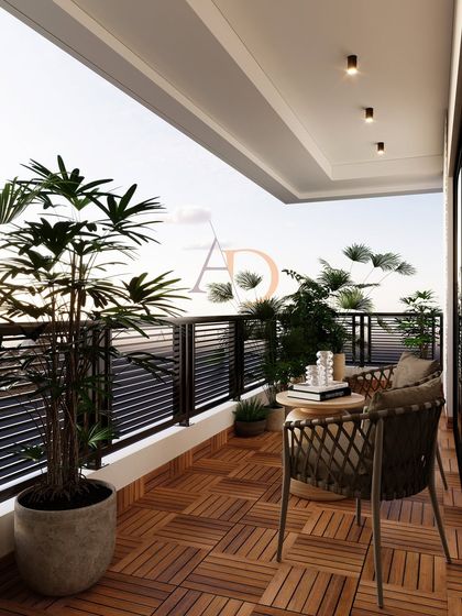 A wider view of the balcony, showing the seating arrangement and the seamless connection to the indoors through large sliding glass doors.