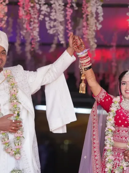 A celebratory moment as the newly married couple raises their hands in joy. We capture the peak emotions and triumphant feelings of your wedding ceremony.