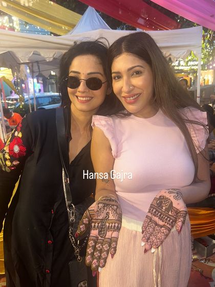 A happy guest showing off her detailed palm mehendi. My team and I ensure every single person feels special and walks away with a design they love.