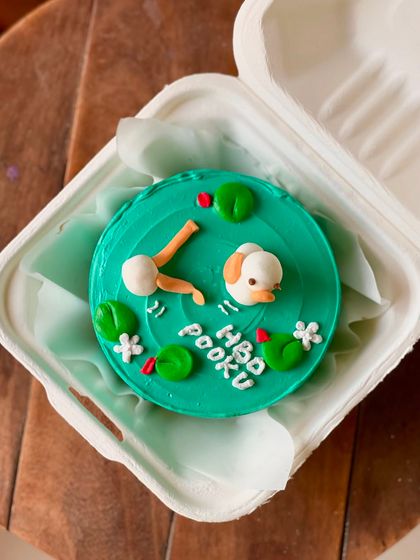 A super cute birthday cake for Pooku, featuring a little duck swimming in a pond with lily pads. The 3D elements make this design extra special.