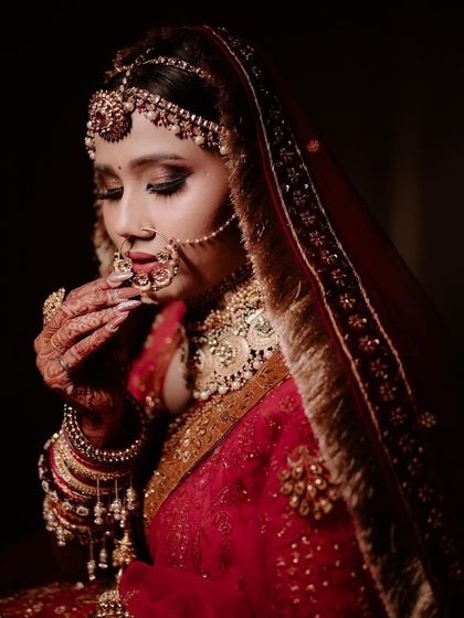A gorgeous bride with a traditional and vintage 'Jodha' look. The makeup is royal and elegant, with a focus on her beautiful eyes.