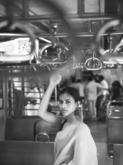 This shot captures the feeling of being in the crowd, yet lost in your own world. The motion blur of other passengers highlights the subject's stillness.