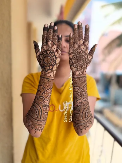 A posed shot showing the full length of the engagement mehendi design.
