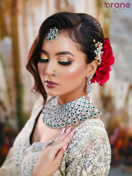 A serene and elegant pose that highlights the soft waves in the hair and the shimmering eyeshadow.