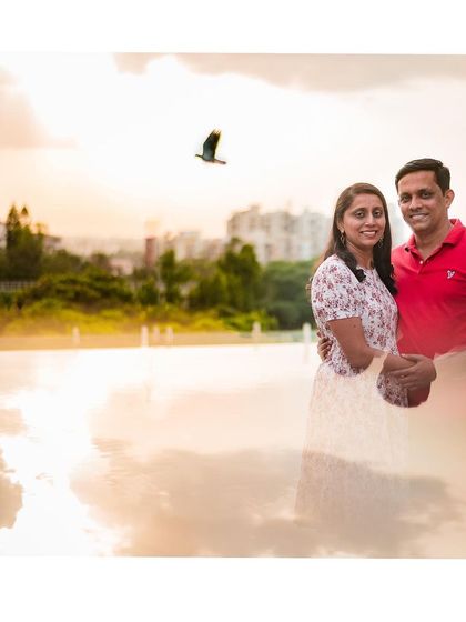 A beautiful double exposure effect combines a portrait of a couple with a dreamy sunset sky, creating a unique and artistic anniversary photo.