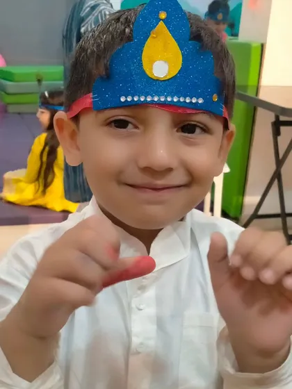 A happy little Kanha showing off his handmade crown. Crafting items for festivals helps children feel more involved and excited about the traditions.