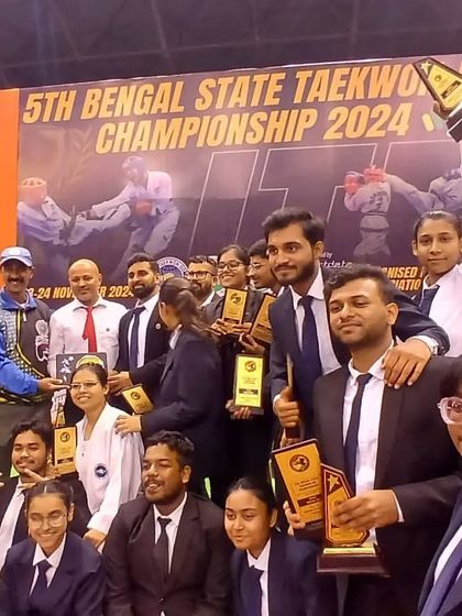 The team proudly displays their collection of trophies and awards from the Bengal State Championship.