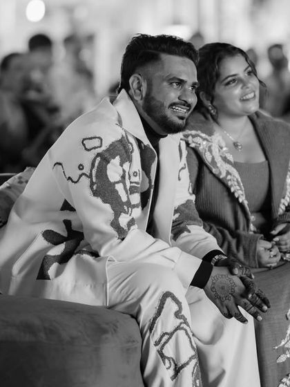 A quiet moment amidst the joyful chaos. The decor serves as a beautiful backdrop for the couple as they soak in the celebration designed just for them.