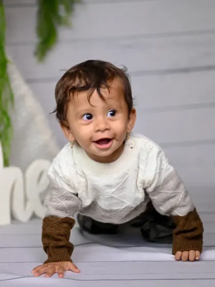 A duplicate of image 143, capturing a happy crawling baby.