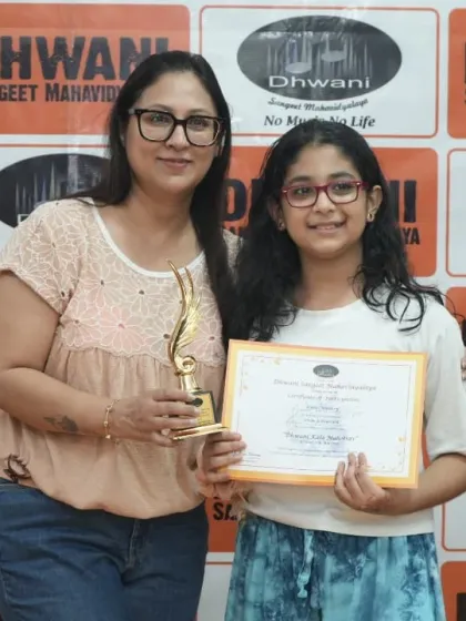 A student with her proud parents receiving her award.