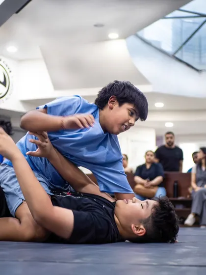 This is Brazilian Jiu-Jitsu in action. Here, two of our young warriors learn to use technique and leverage, not just size, to control a situation. It's a physical chess match that builds critical thinking under pressure.