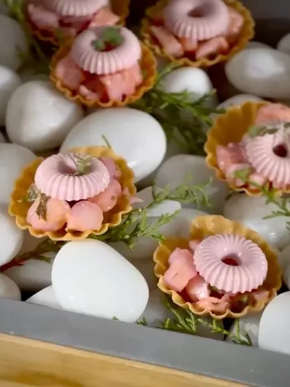 A single bite can tell a whole story. These are my inventive chaat tarts, a modern take on a classic street food, presented on a bed of white stones. It’s an example of how I transform familiar flavors into an elegant, bespoke canapé.