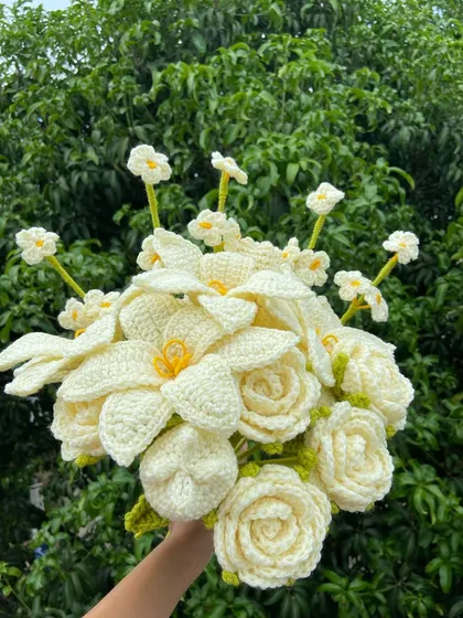 An elegant all-white custom bouquet featuring lilies, roses, and forget-me-nots.
