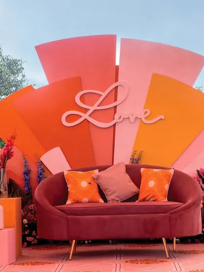 The main seating area for our 'Spectrum of Love' Haldi theme. This vibrant, multi-layered backdrop with a custom 'Love' cutout creates the perfect photo-worthy moment, capturing the joy and energy of the celebration.