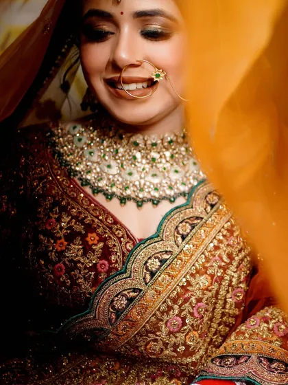 A joyful bridal portrait, capturing a beautiful, natural smile as the veil flows around her.