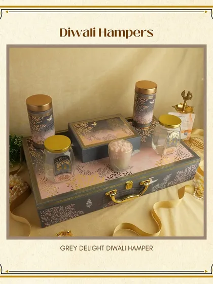 The 'Grey Delight' Diwali Hamper. This elegant suitcase-style box has a beautiful design and can be filled with a variety of festive goodies like dry fruits, candles, and sweets.