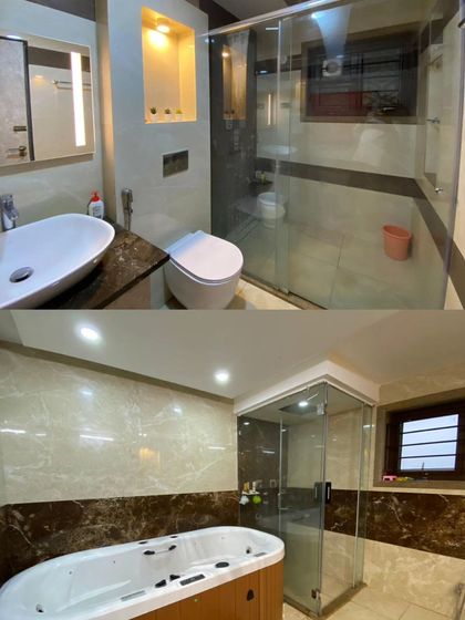 The bathrooms in the residence are luxurious, featuring marble walls, glass shower enclosures, and modern fixtures, with one even including a jacuzzi tub.