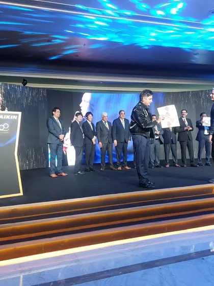 Presenting the magically revealed winner's name to an audience member at the Daikin awards. This kind of personalized reveal makes the award ceremony truly special.