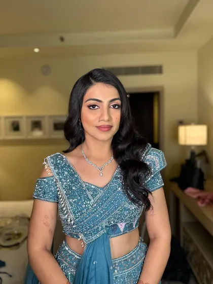The final look is a perfect blend of classic hairstyle and contemporary fashion, ideal for a wedding reception or cocktail party.