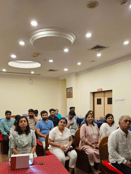 A group of attendees listening intently during a meditation session at the Third Eye workshop.