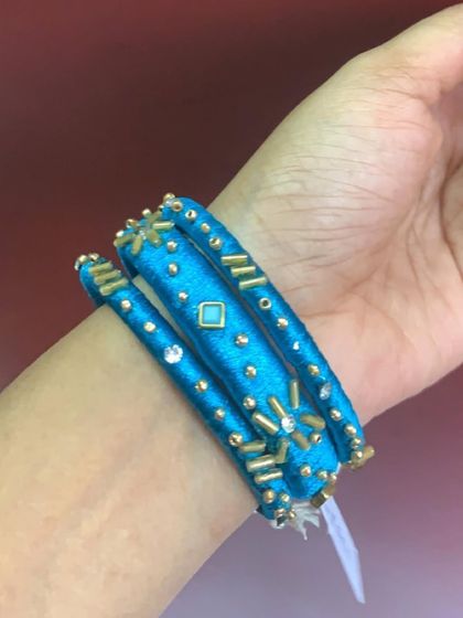 Explore my range of blue silk thread bangles, featuring different styles with kundan stones, coins, and pearl embellishments.