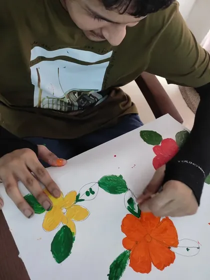 This young artist is carefully adding details to his floral painting. Art camp is a space for exploration, imagination, and observation, and it's a joy to see them so engaged.