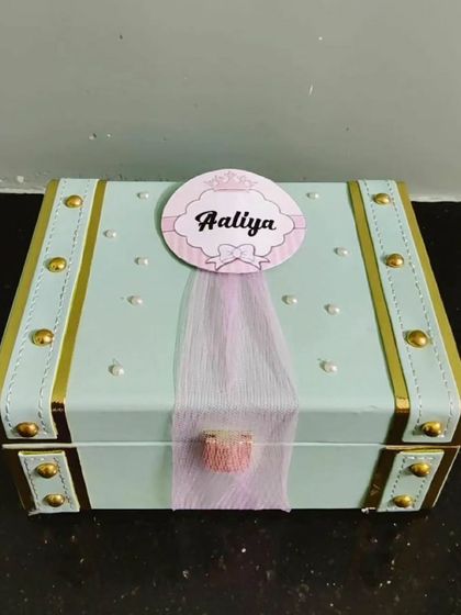 A personalized trunk for a sister named Aaliya. The pastel colors and custom tag make it a sweet and personal gift.