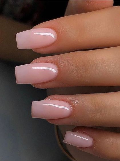 Sometimes, less is more. This image shows a perfectly executed set of simple, clean, nude-pink acrylic nails in a classic square shape, proving that flawless application is an art in itself.