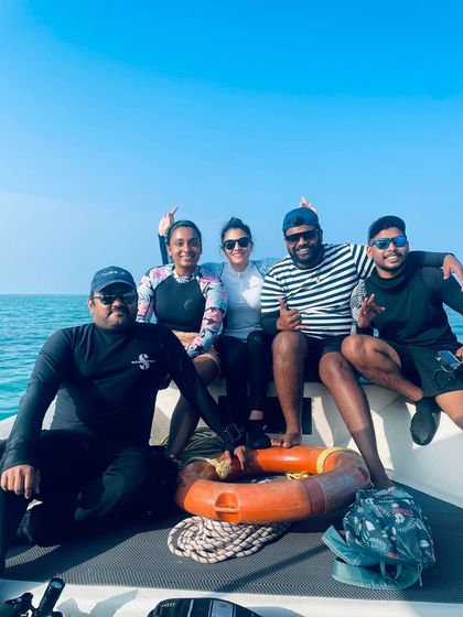 A group of friends enjoying the boat ride. The journey is just as beautiful as the destination.