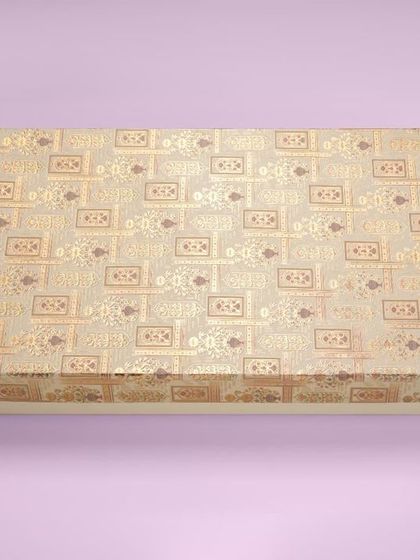 A rectangular gift box with a traditional gold pattern, shot against a solid pastel background. We use colored backgrounds to make catalogue images more vibrant.