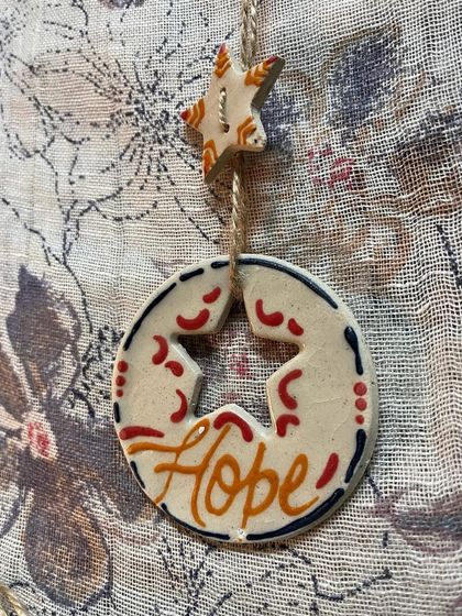 My 'Hope' affirmation ornament, designed with a star cut-out. It's a reminder to hold onto hope during the festive season and beyond.
