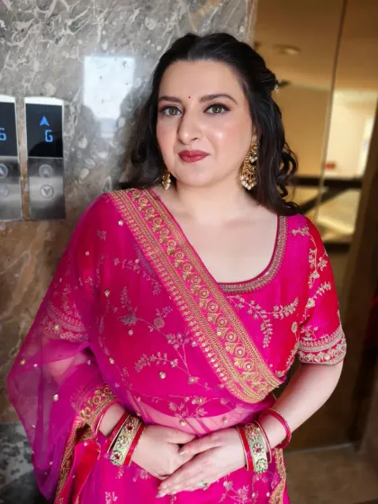 A front-facing portrait capturing the soft glam makeup and elegant curled hairstyle. This look is perfect for a wedding guest who wants to look polished and beautiful.