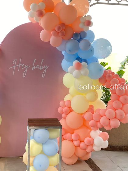 A closer look at the pastel balloon arch, showing the beautiful color combination and flower-shaped balloon details.
