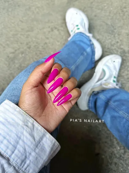 Another shot of these stunning, long stiletto nails in a powerful magenta shade.