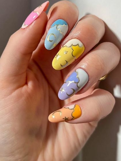 Another view of the beautiful pastel celestial nail art, showcasing the different colors and delicate gold details.