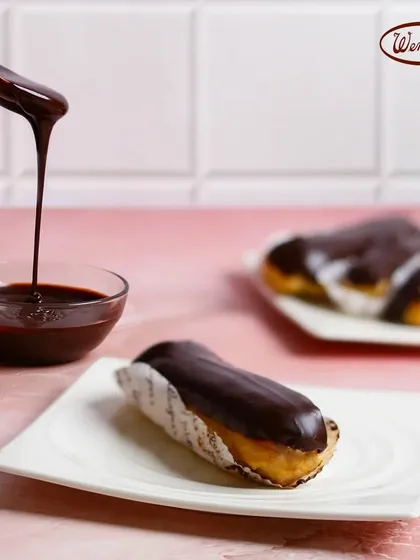 A classic French Chocolate Eclair, filled with delicate cream and topped with a rich, glossy chocolate glaze. This is one of the timeless pastries that our regulars have loved since the very beginning.