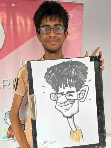A student from the science festival, very happy with his exaggerated caricature.