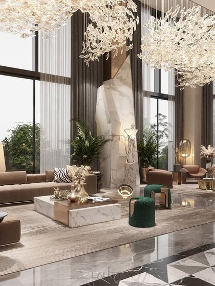 A closer look at the seating arrangement in the double-height living room. We used a mix of neutral sofas, green poufs, and a large-scale sculpture to ground the immense volume of the space, making it feel both grand and intimate.