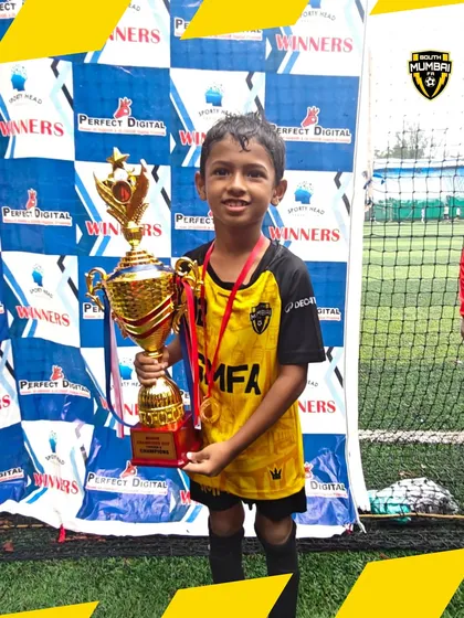 A young champion from our U8 squad proudly holding the tournament trophy. This is the result of heart, hustle, and relentless spirit.