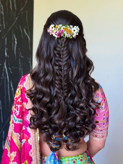 A full back view of the Mehandi hairstyle, perfect for a bride who loves color and detail.